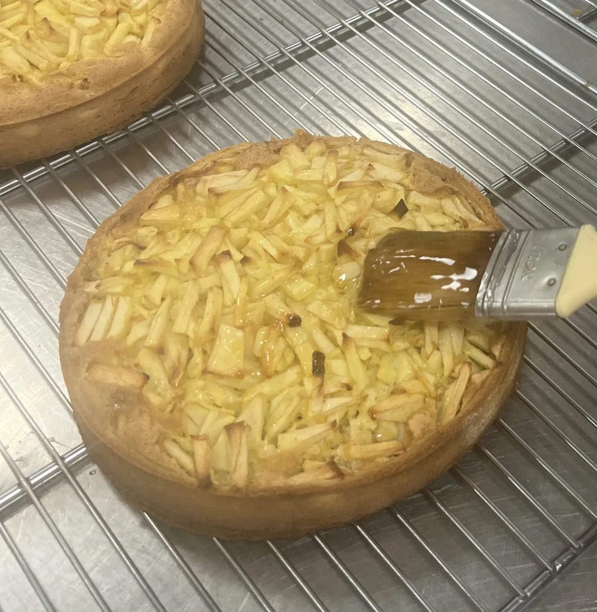 Glazing a baked Breton apple tart