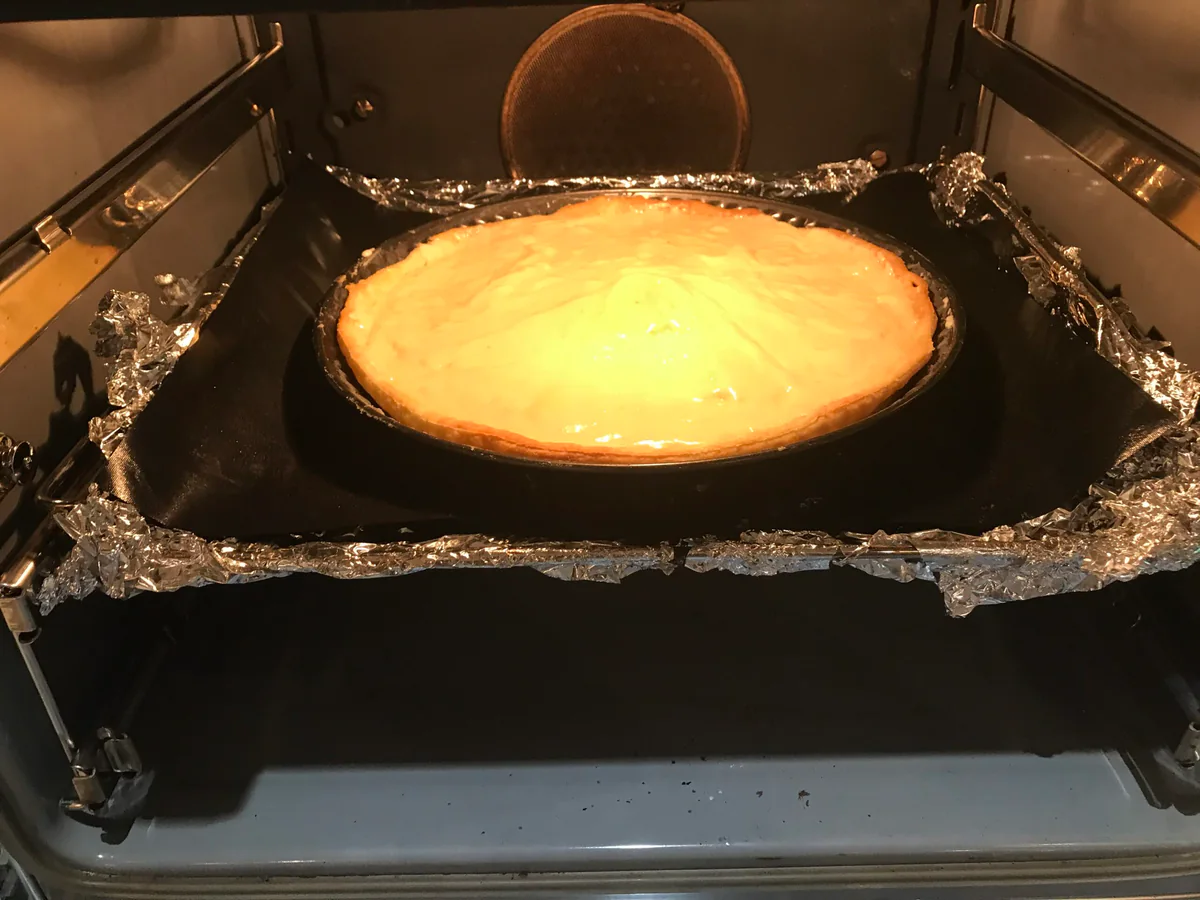 Frangipane tart baking in the oven.
