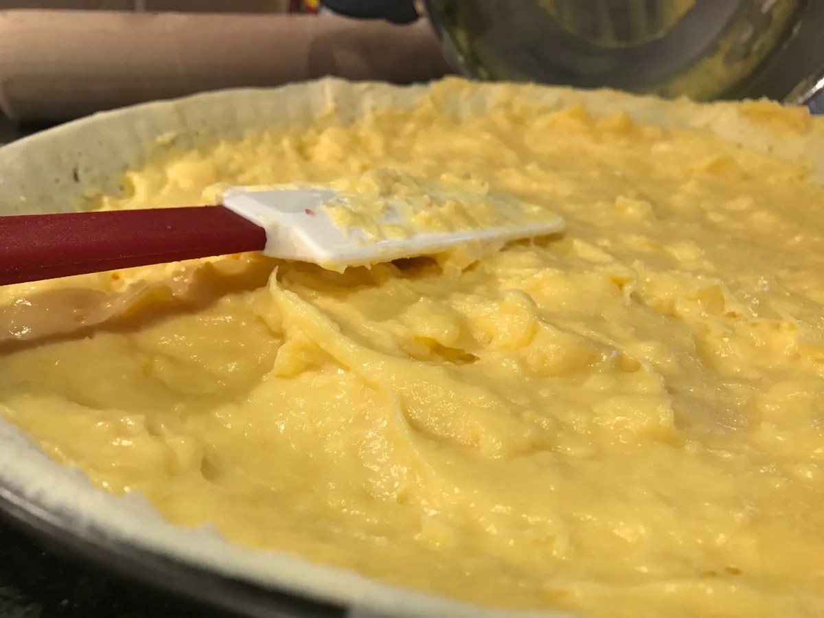 Mixing the tart filling with a spatula.