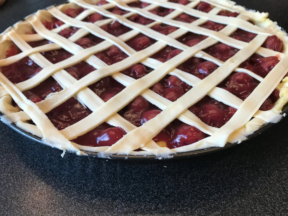 Diamond pattern of pastry strips on the sour cherry tart.