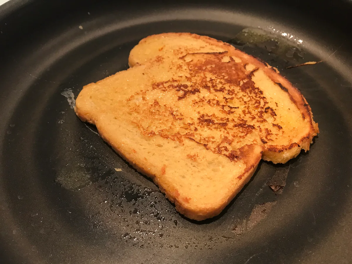 Golden-brown French toast in a pan.