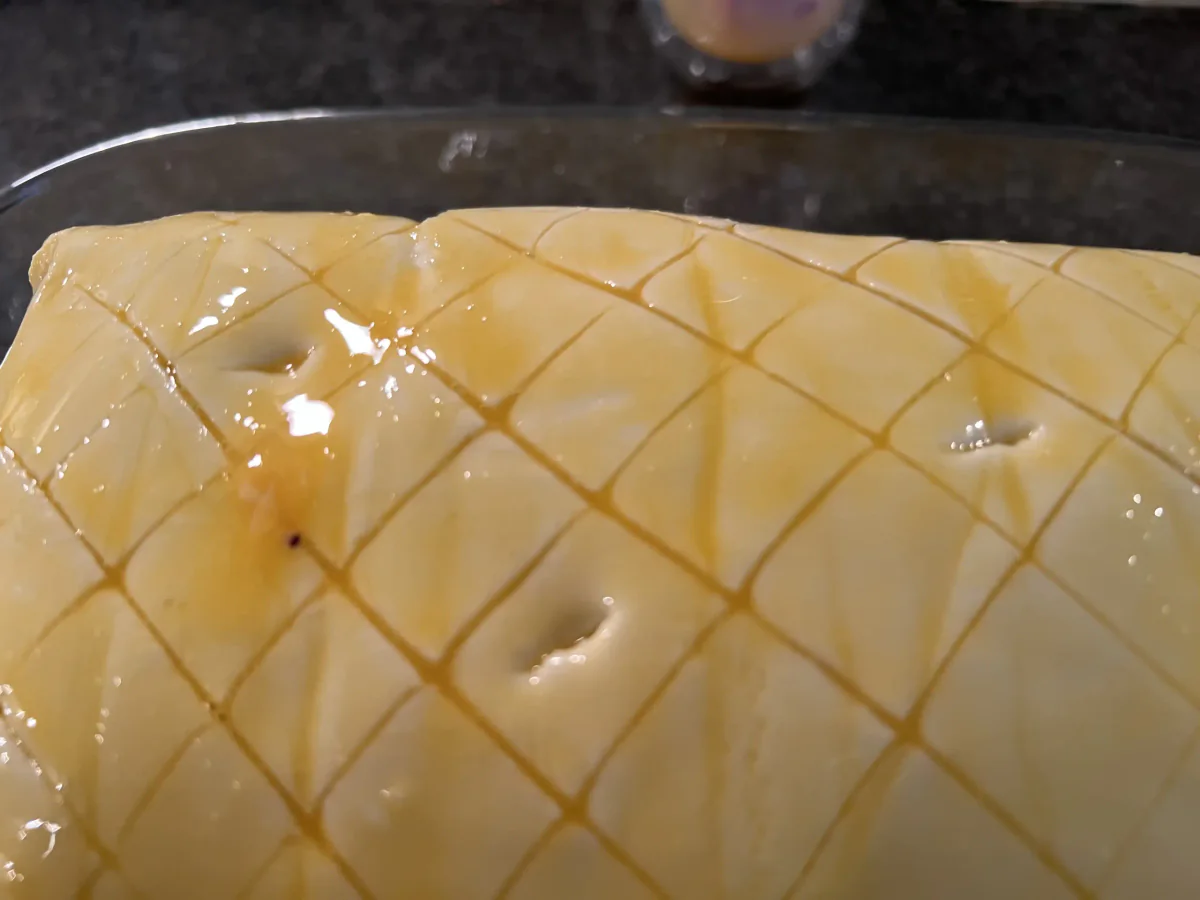 Puff pastry with a scored diamond pattern and an egg wash.