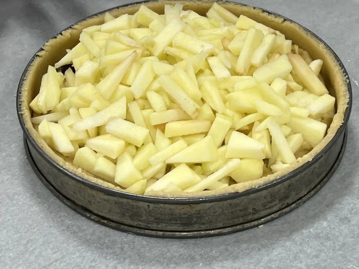 Mit Apfelstreifen gefüllte Tarteform.