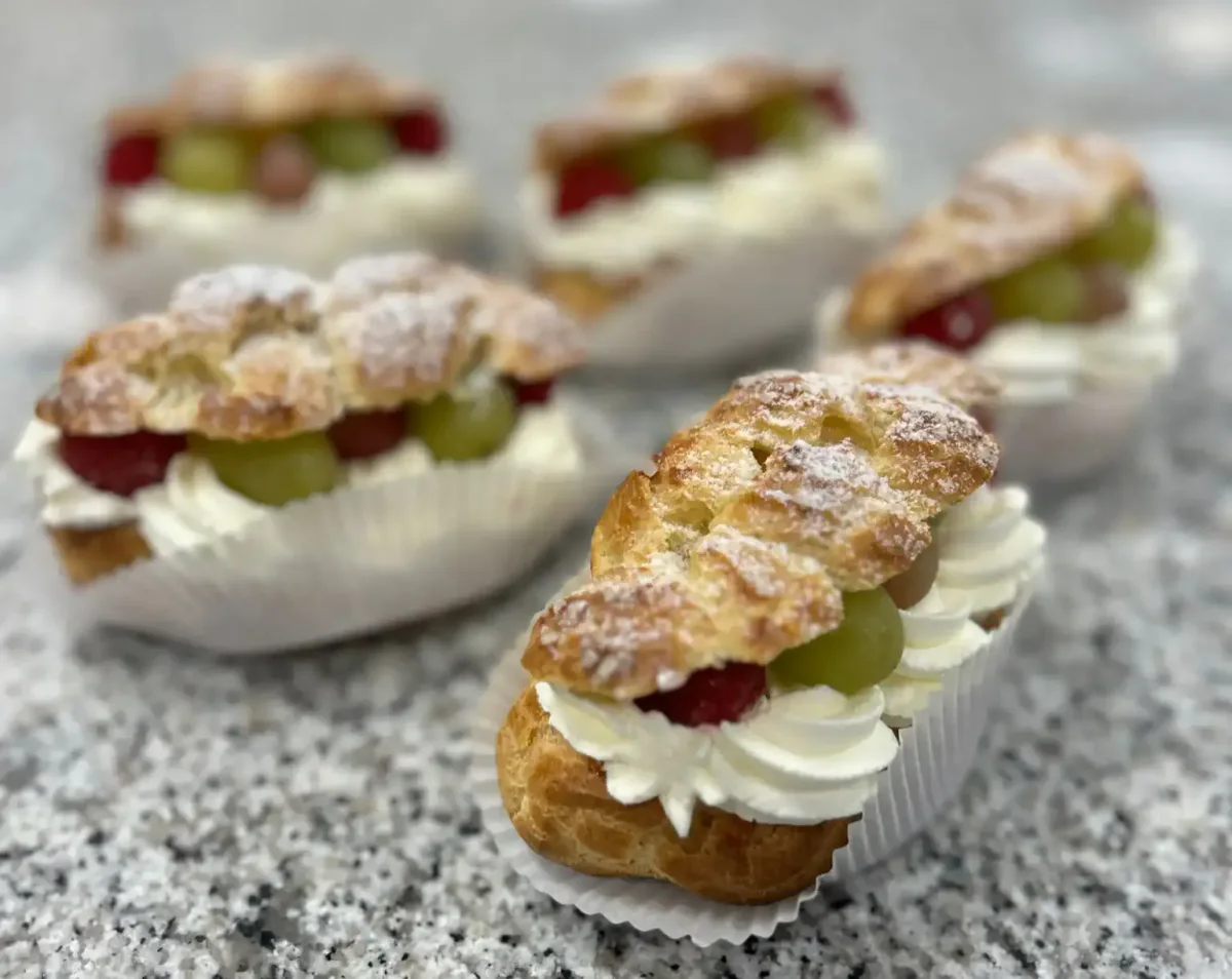 Éclairs filled with crème royale, fruit and whipped cream