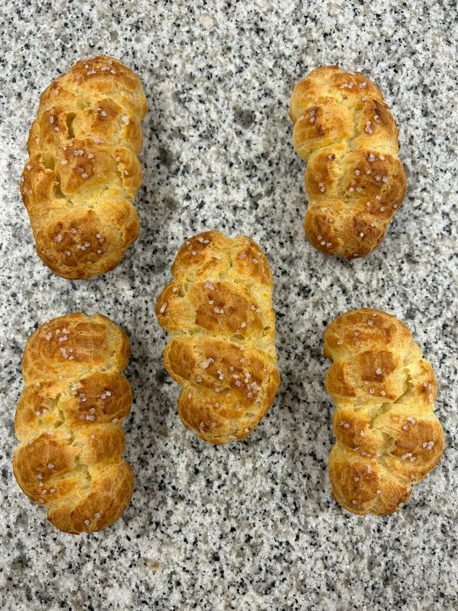 Baked choux pastries dusted with icing sugar.
