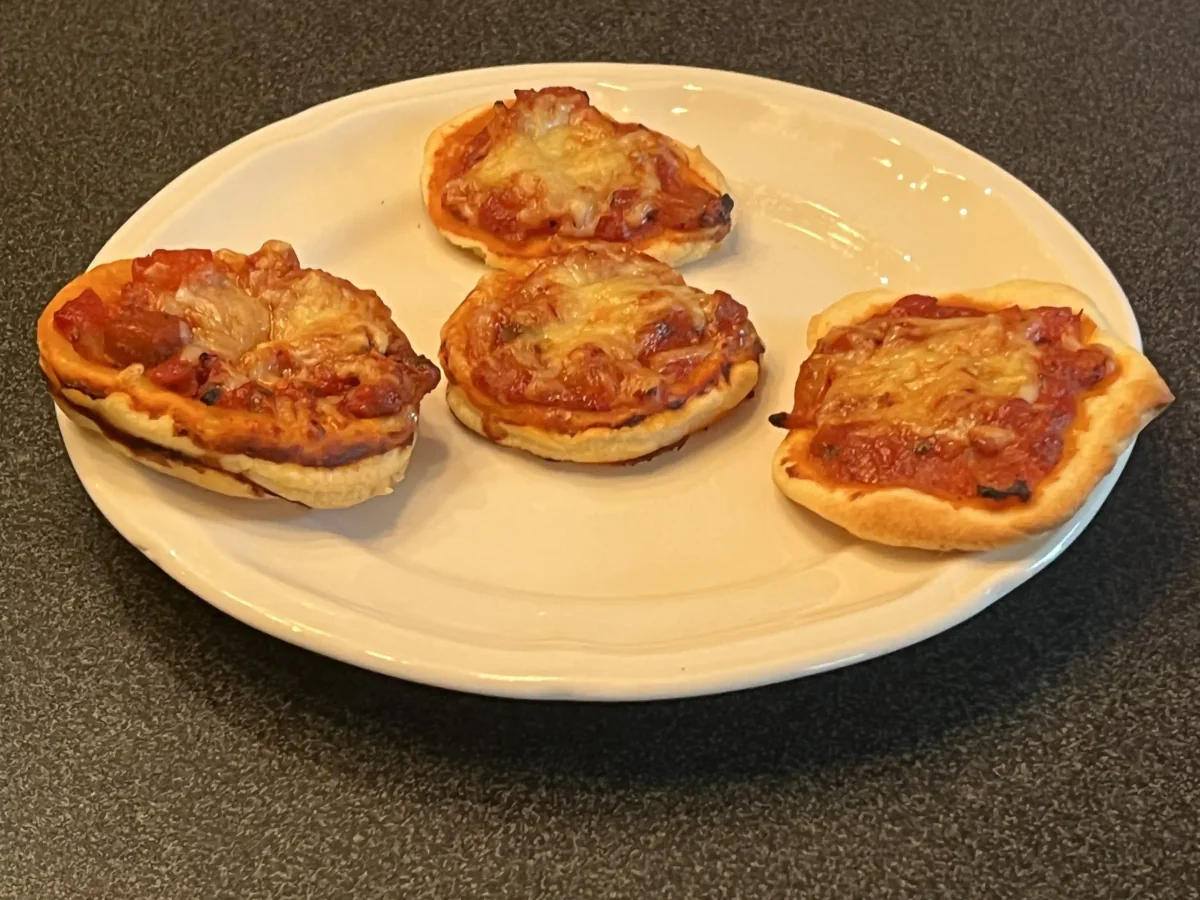 Mini puff-pastry pizzas topped with leftover spaghetti sauce and cheese