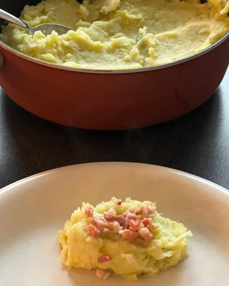 Mashed potatoes and vegetables with bacon on a plate and in a pan.