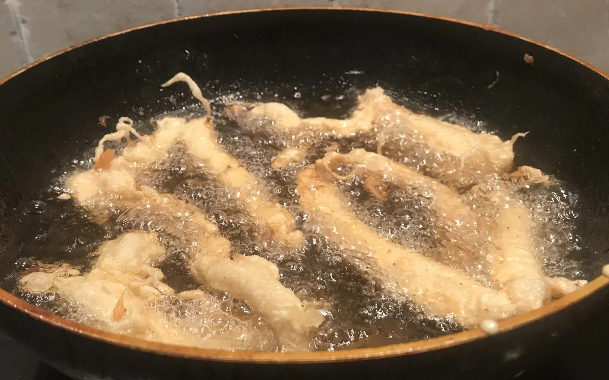 Frying tempura-battered fish in oil