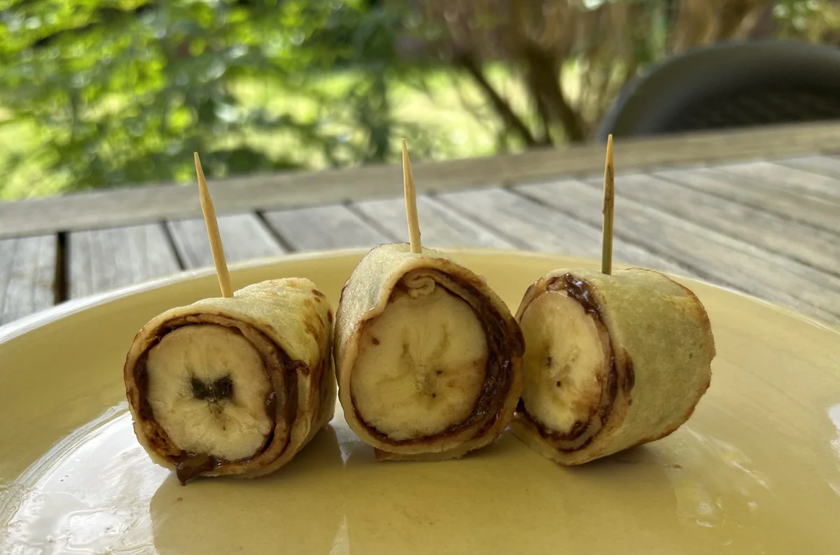 Pancake rolls filled with banana and Nutella, cut into sushi-style bites