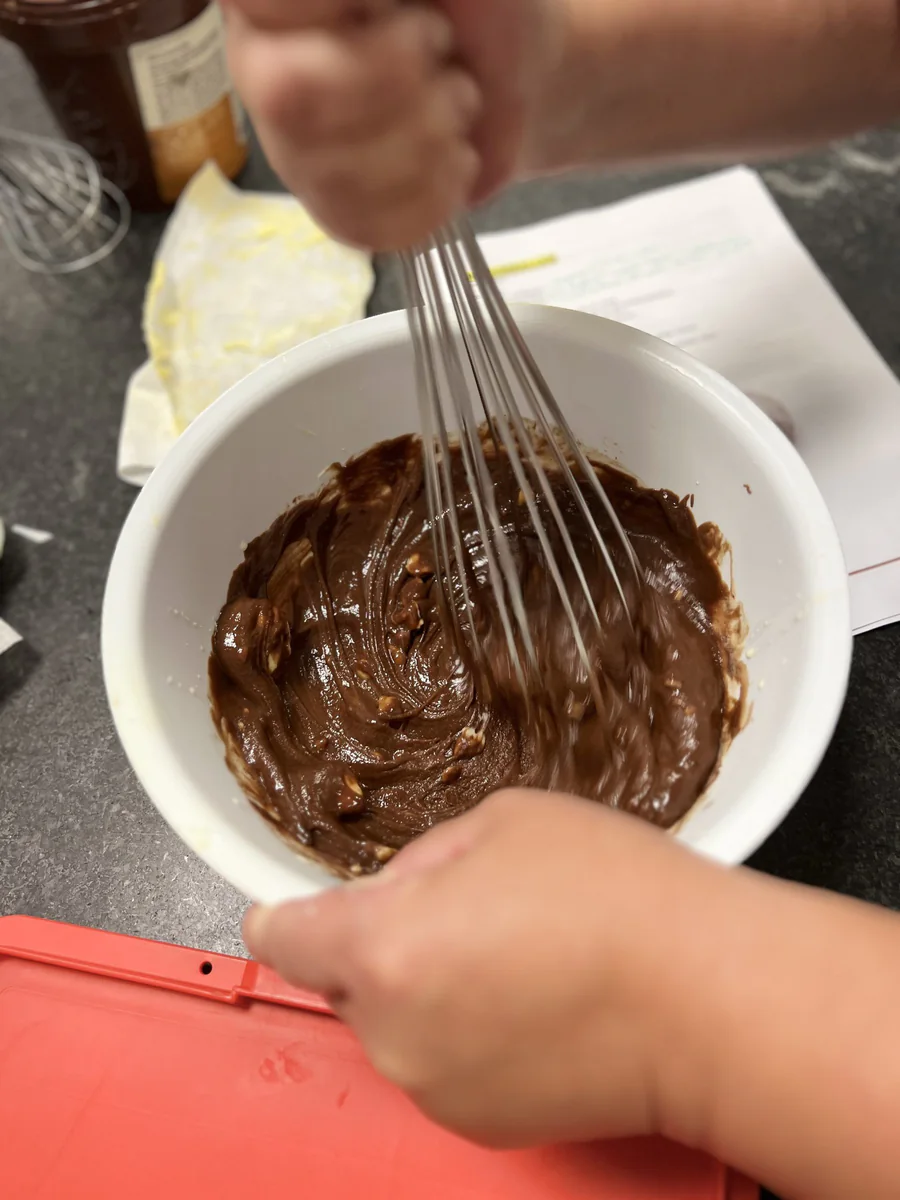 Mixing ganache with a whisk.