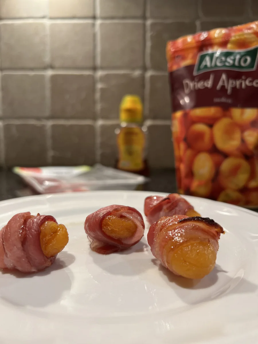 Dried apricots wrapped in bacon and baked until crisp