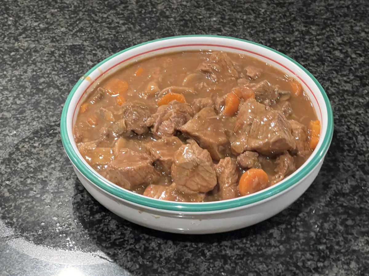 A dish of Flemish beef stew with carrots.
