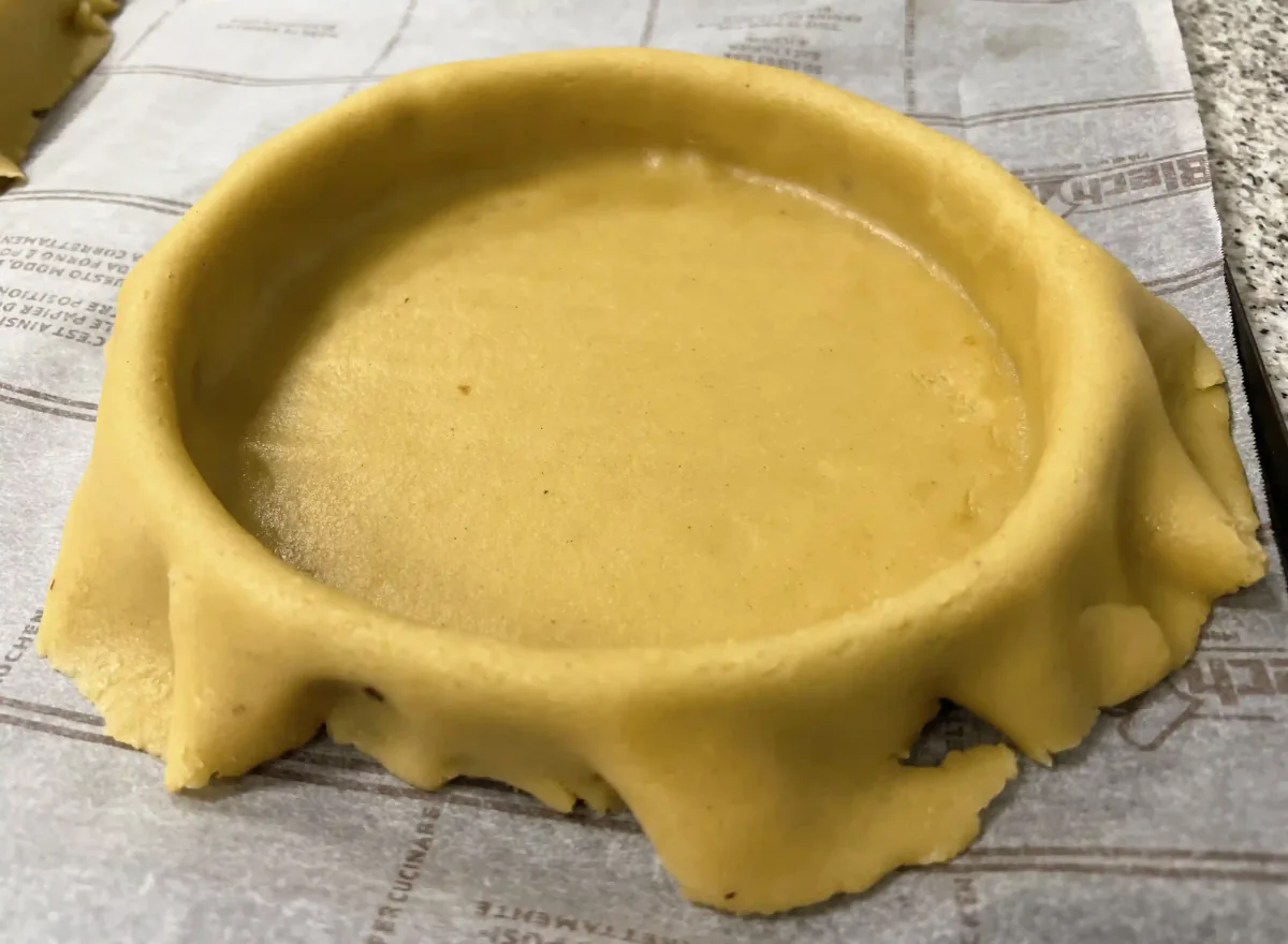 A round tart tin lined with pastry.