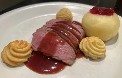 Duck breast with red port sauce and berries with warm apples